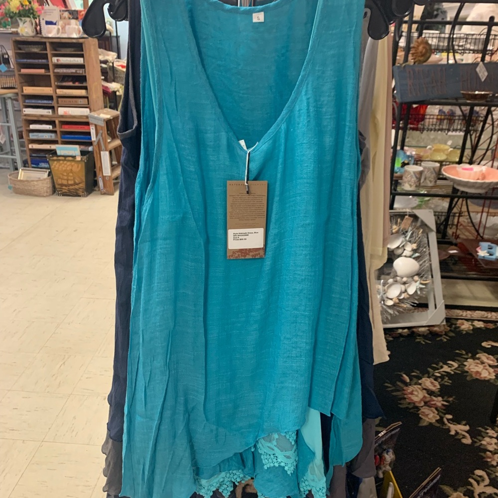 Turquoise dress with layered, Lacey detail on hem. All sizes available.